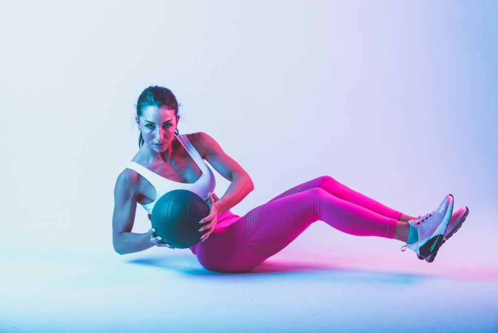 Woman training with the exercizes ball in the gym